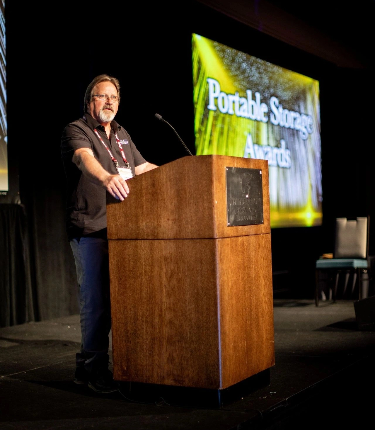 Greg Cravens of 360 Products at the POrtable Storage Awards - speaking at the podium - NPSA 2026 Innovative Award for their shipping container vent system, DRY-CON X®